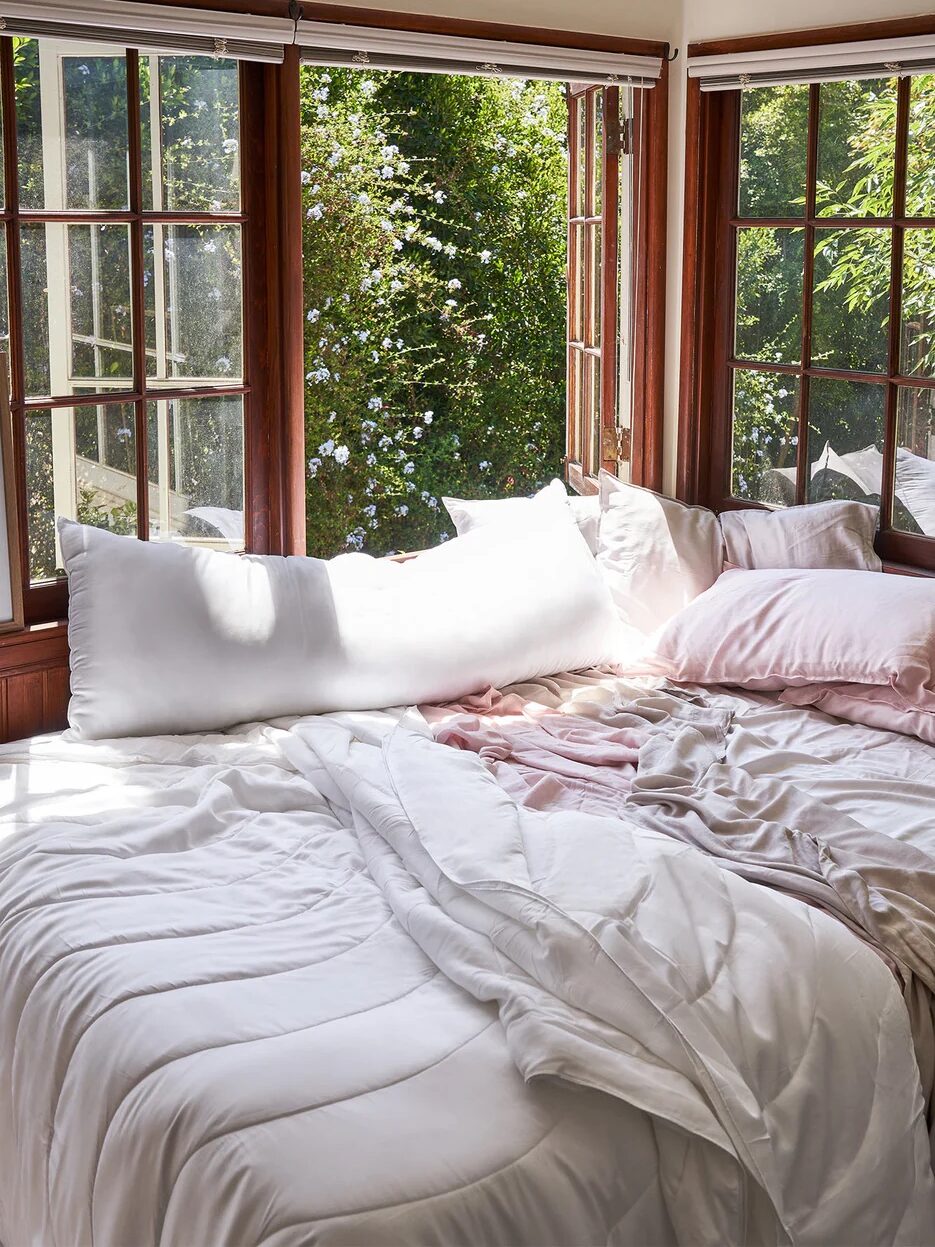 A bed with a Buffy pillow on top of it.