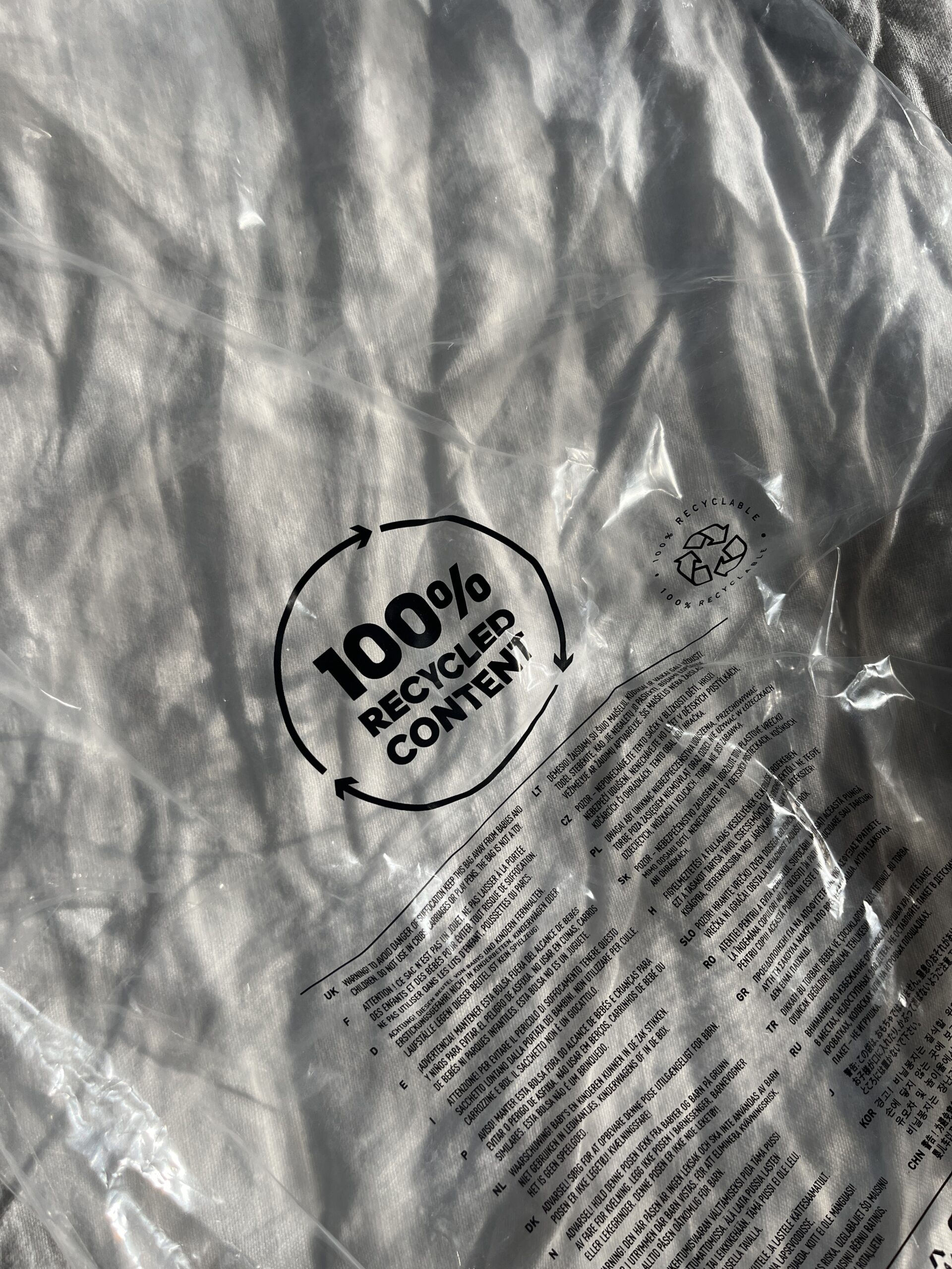 A plastic bag with the words "100% Recycled Content" printed on it.