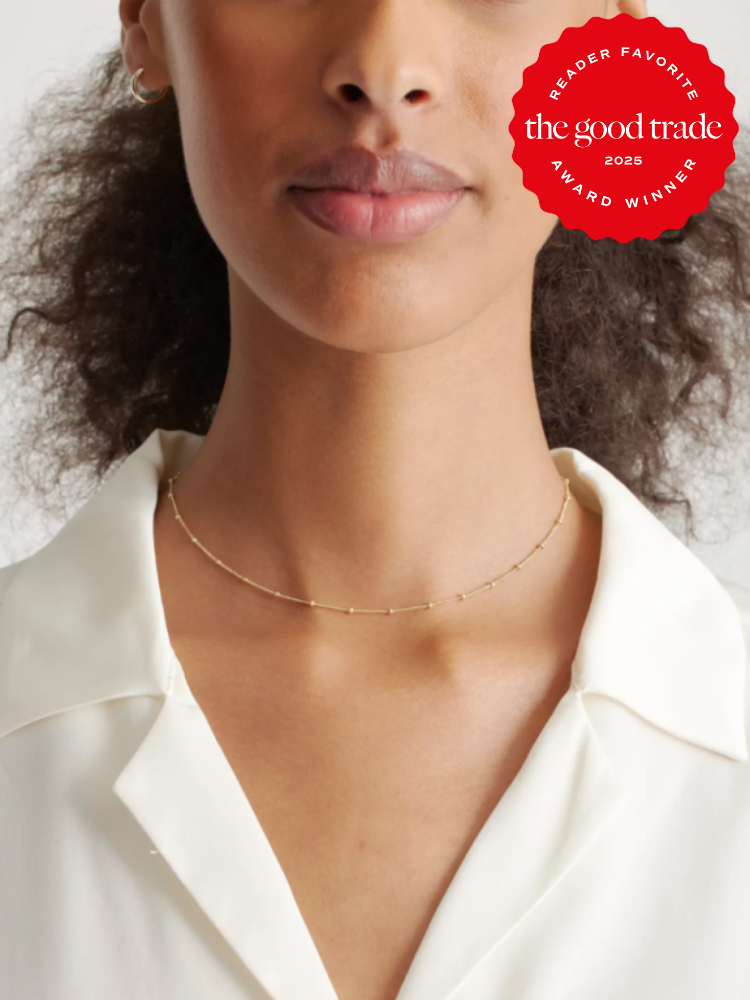 A woman wearing a simple gold necklace and a white blouse. A red badge reads "Reader Favorite, the good trade, 2025 Award Winner.