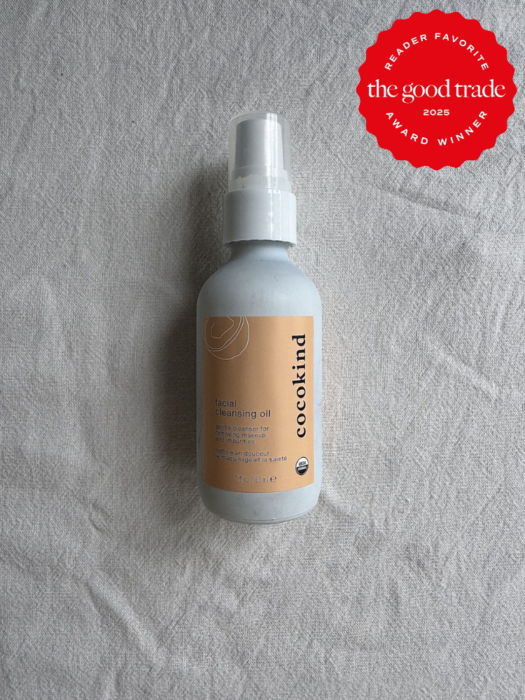 Bottle of Cocokind facial cleansing oil on a textured surface. A red badge indicates it as a 2025 reader favorite by The Good Trade.