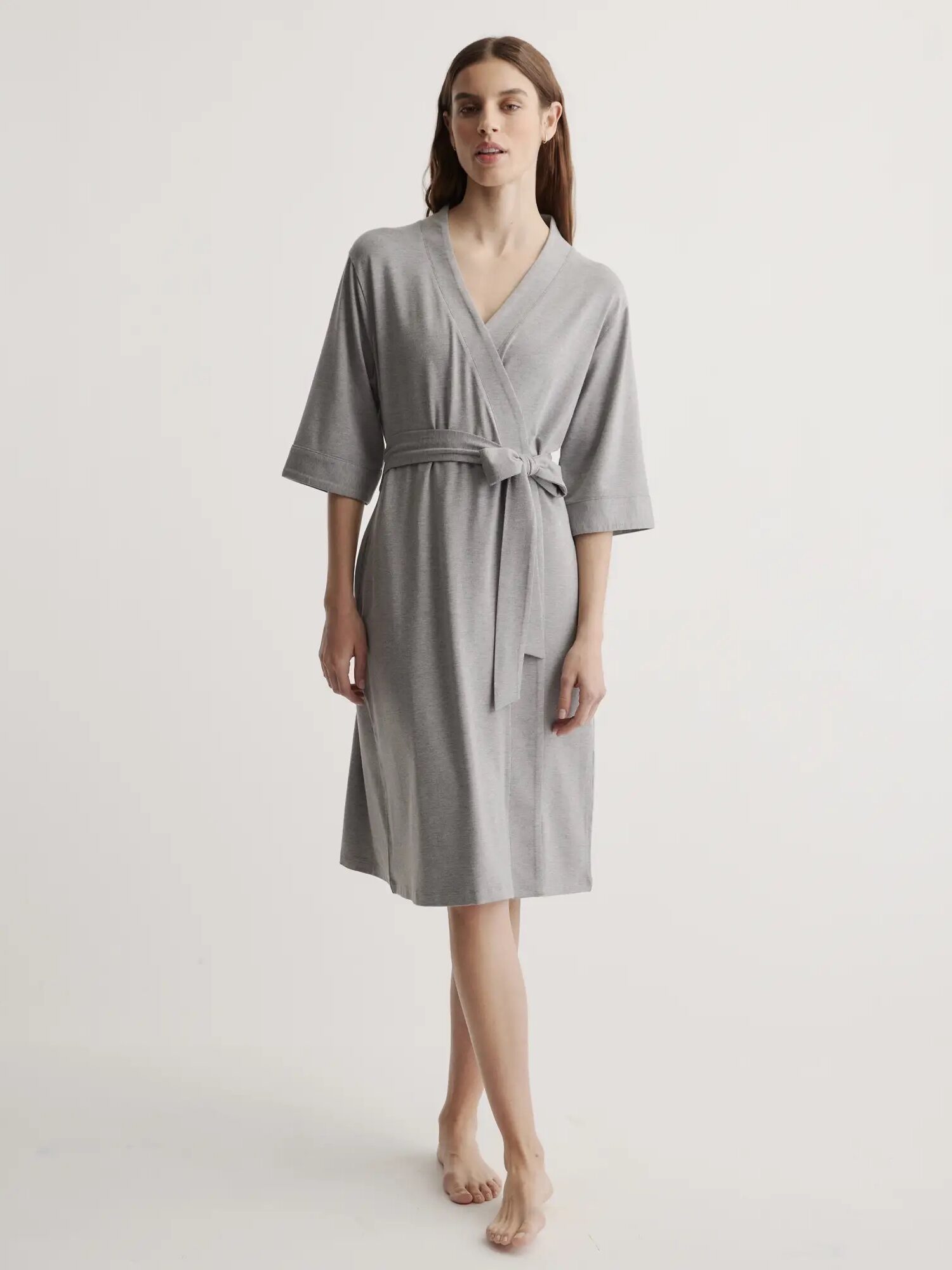 A model wearing a grey Quince robe. 