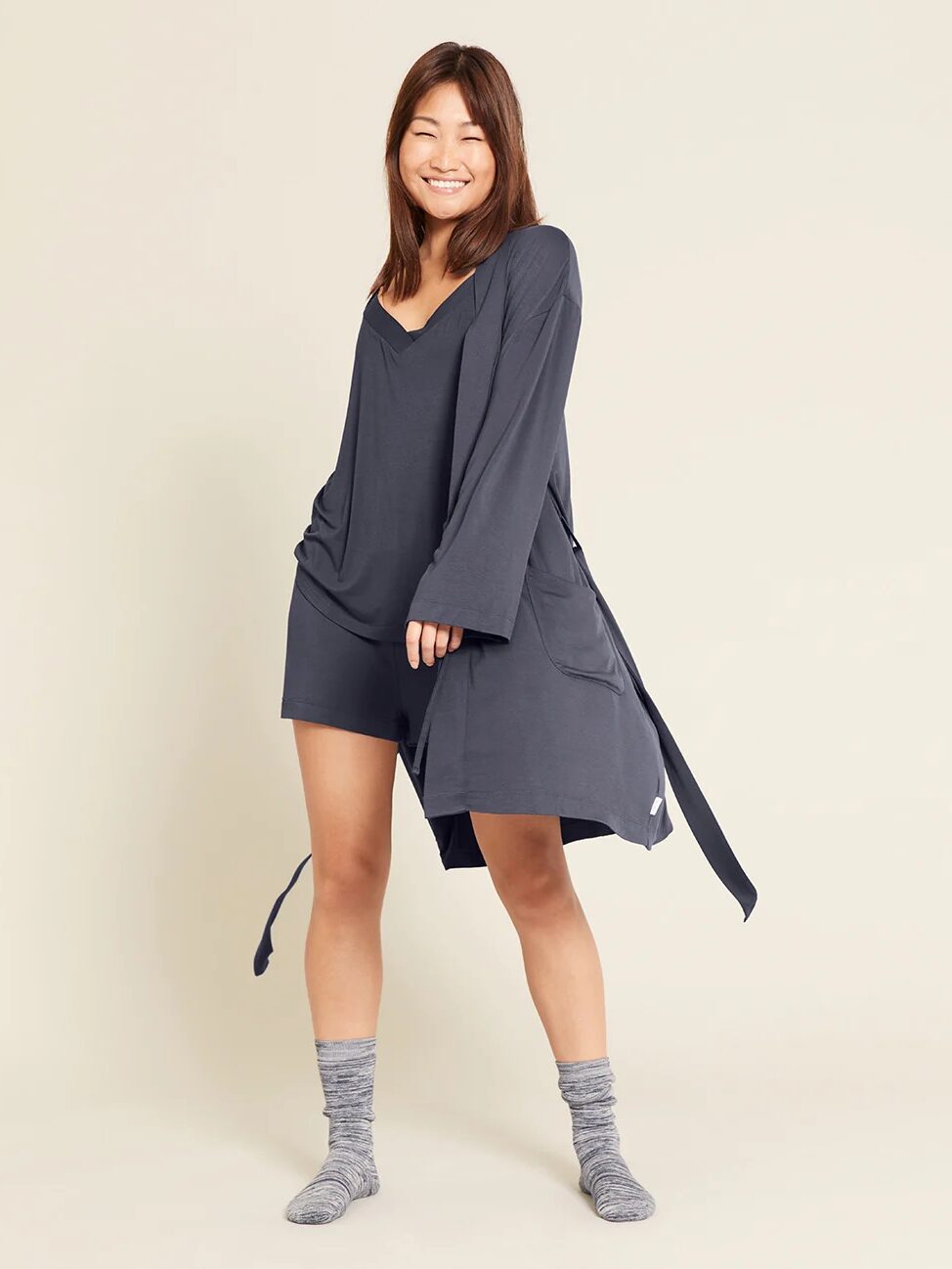 A model wearing a blue robe from Boody.