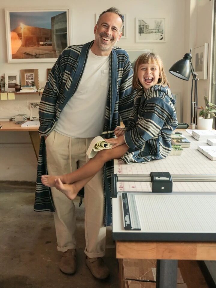 An adult model and a child model wearing ODDBIRD robes. 