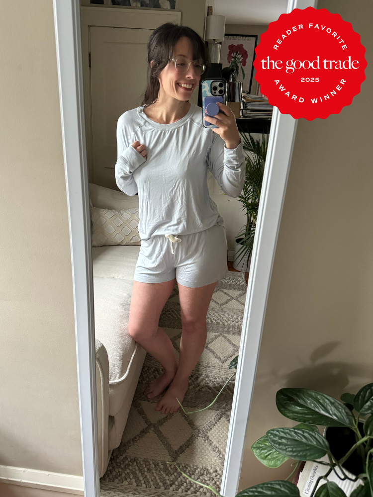 Person in light-colored loungewear taking a mirror selfie in a cozy room with a sofa and plants. "The Good Trade 2025 Reader Favorite Award Winner" badge on the top right.