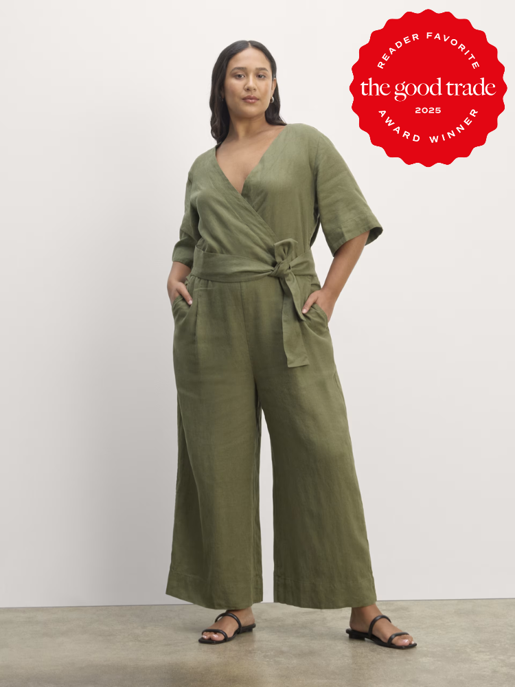 Person in a green wrap jumpsuit with hands in pockets, standing against a plain backdrop. A red award badge for "The Good Trade 2023 Reader Favorite" is displayed in the top right corner.