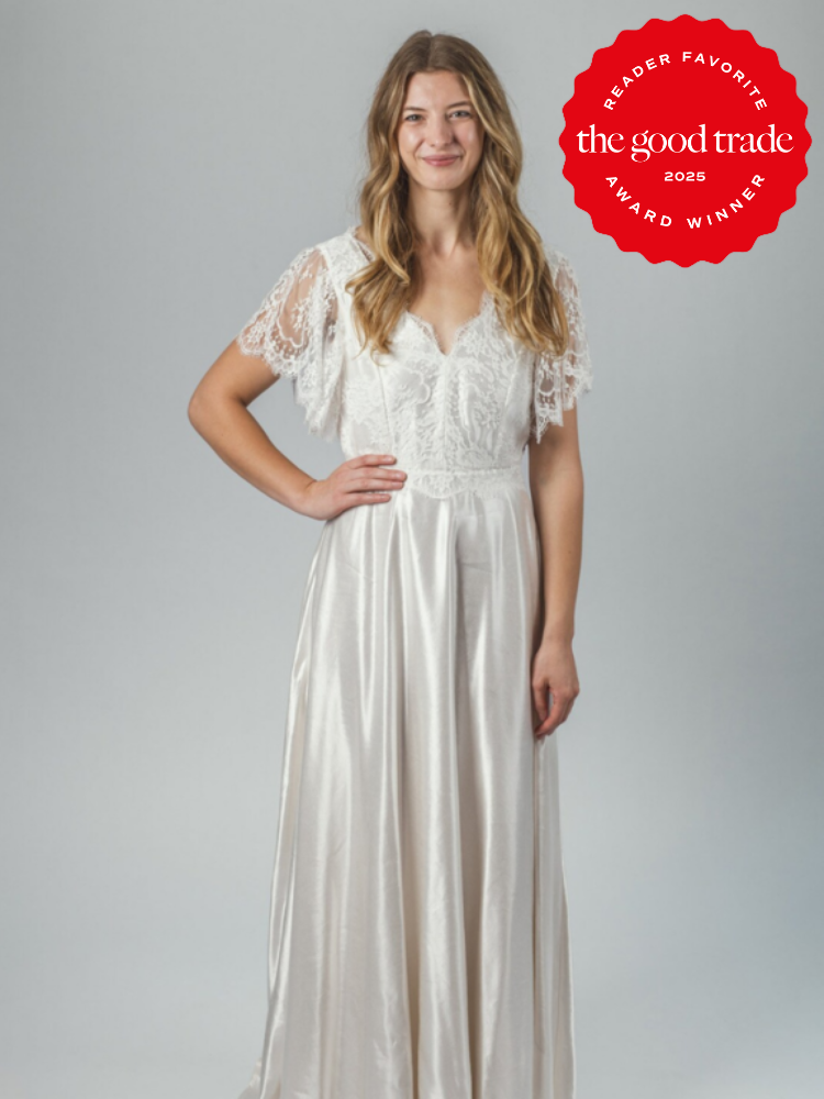 A woman stands wearing a white dress with lace sleeves, smiling. A red badge on the image reads "Reader Favorite, the good trade, Award Winner 2025.