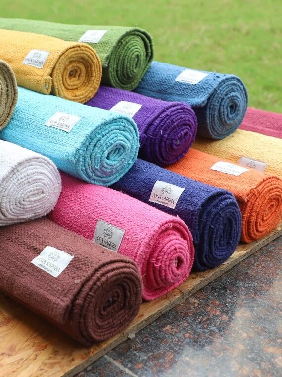 A stack of rolled yoga mats from YogaKargha. 