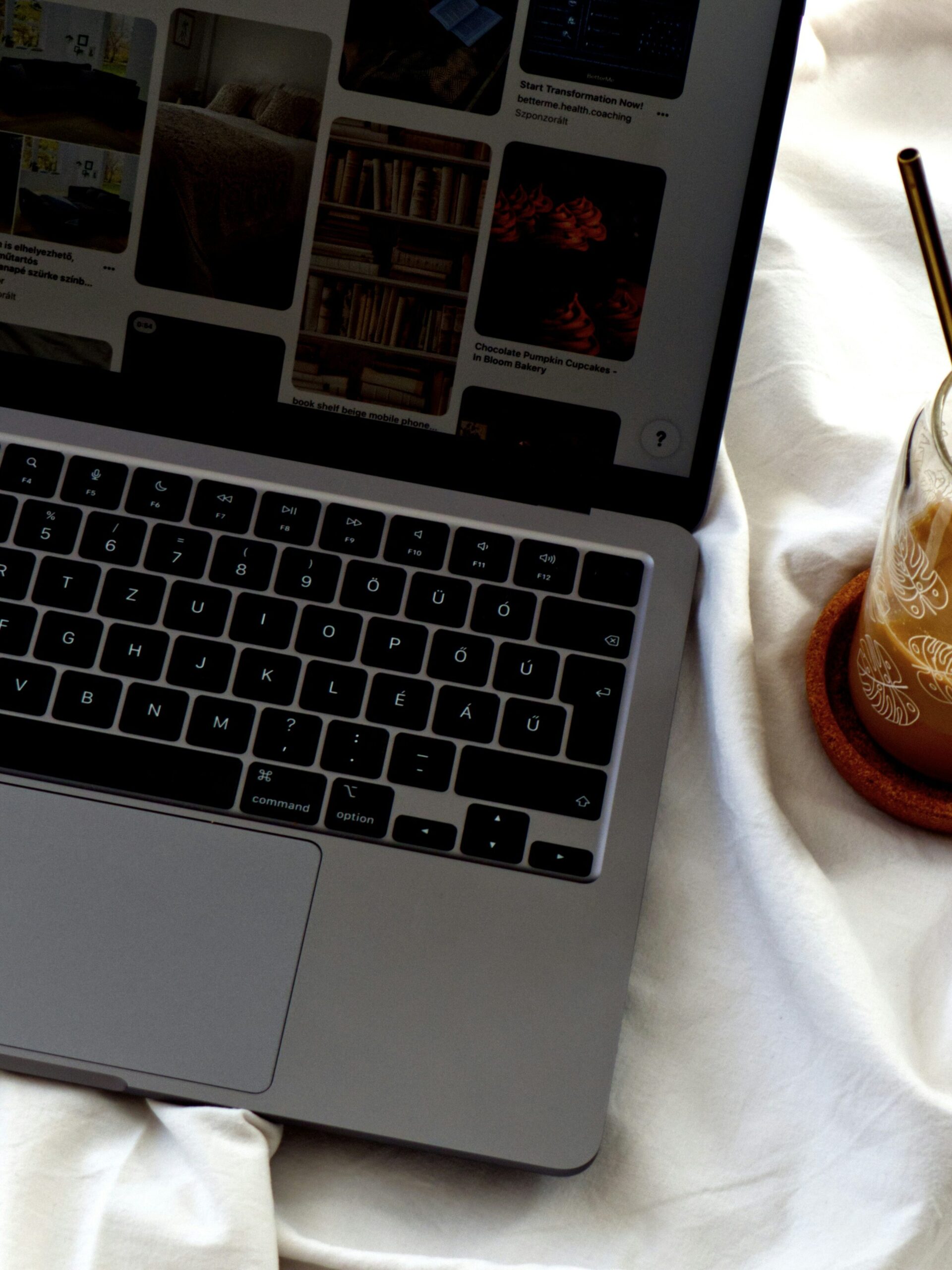 A close up of a laptop opened to the Pinterest homepage.