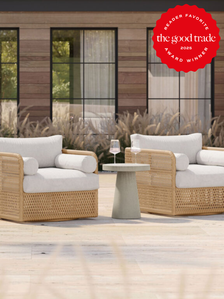 Two wicker chairs with white cushions and a small table holding a wine glass on a patio. A "Reader Favorite" award seal is in the top right corner.