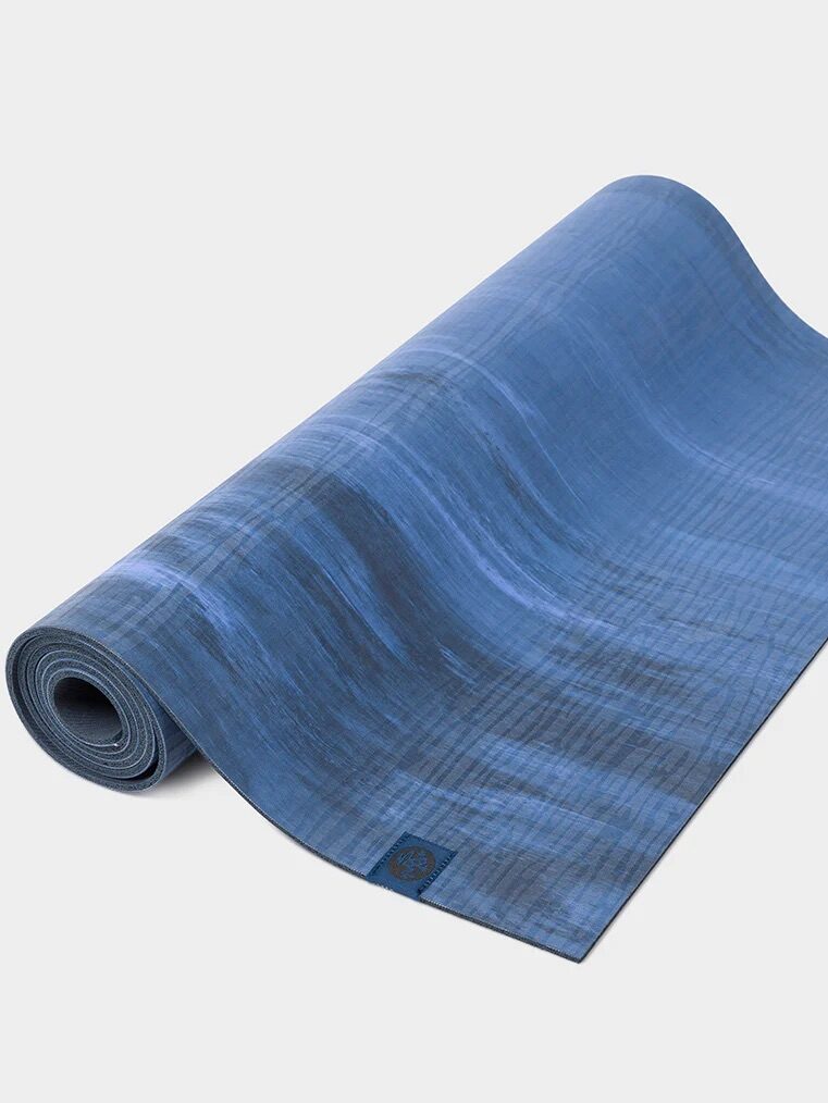 A rolled up yoga mat from Manduka. 