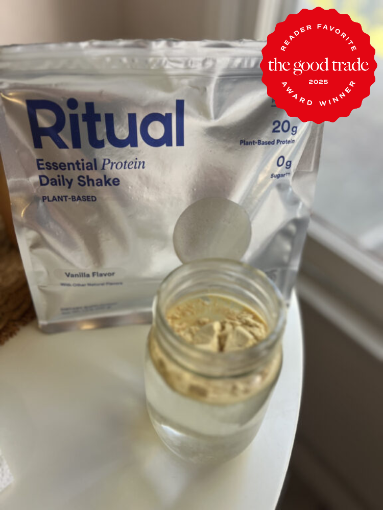 Ritual Essential Protein Daily Shake in vanilla flavor next to a glass of liquid; features a "Reader Favorite" award badge from The Good Trade.