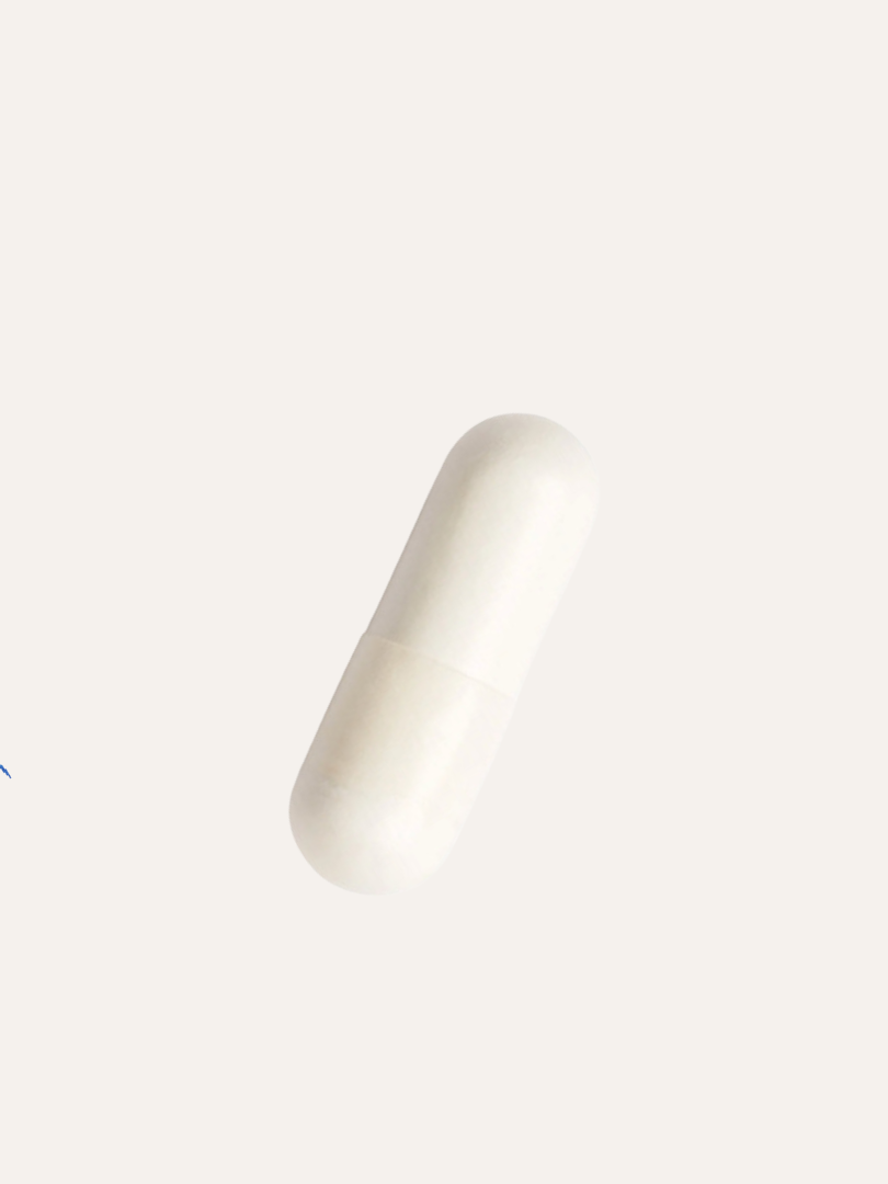 A single white capsule pill on a plain light background.