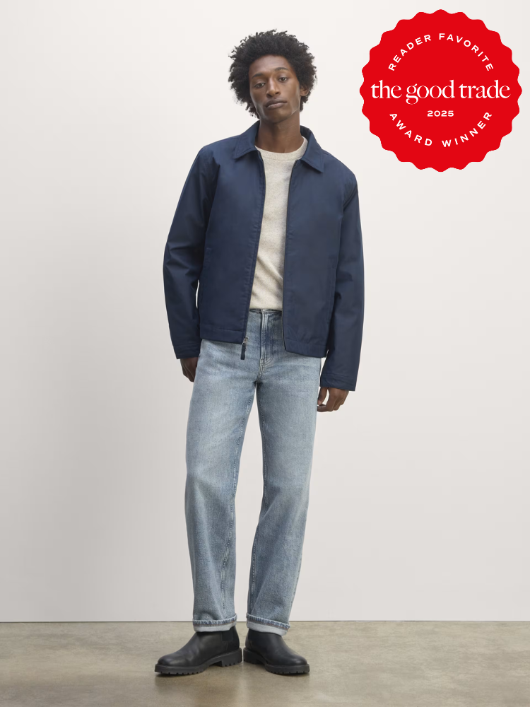 Person in a blue jacket and jeans stands in a studio setting. Red award badge on top right corner reads "The Good Trade 2025 Reader Favorite Award Winner.