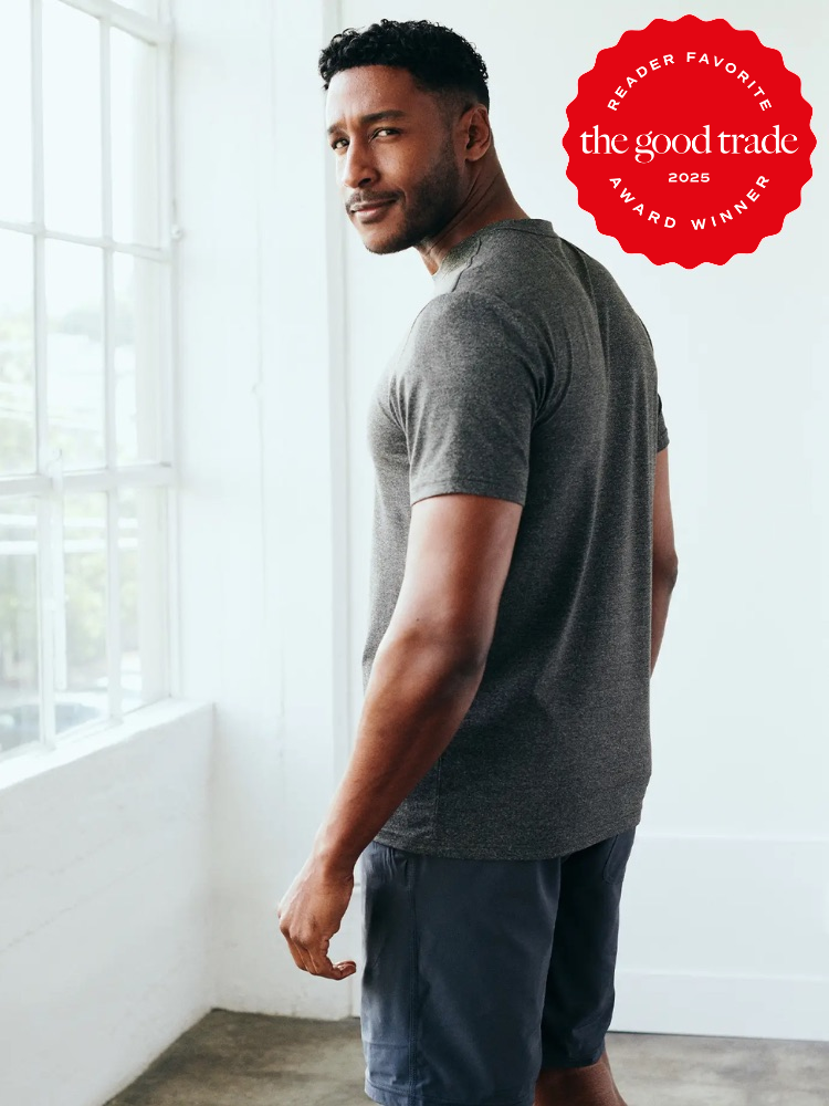 Man in gray shirt and shorts stands near a bright window. A red "Reader Favorite" badge from "The Good Trade" is in the top right corner.