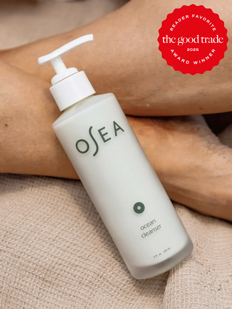 A bottle of OSEA Ocean Cleanser with a pump top, resting on a textured fabric. A red badge on the image indicates it as a 2023 "The Good Trade" reader favorite award winner.