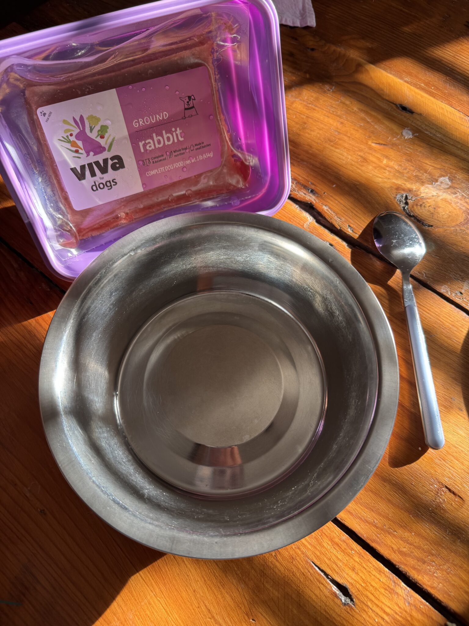 A bowl and spoon on a table.