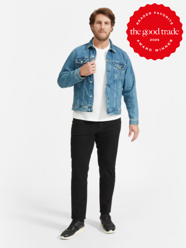 Man in a denim jacket, white shirt, and black pants standing against a white background. There's a red award badge saying "the good trade - Reader Favorite Award Winner 2025" on the top right.