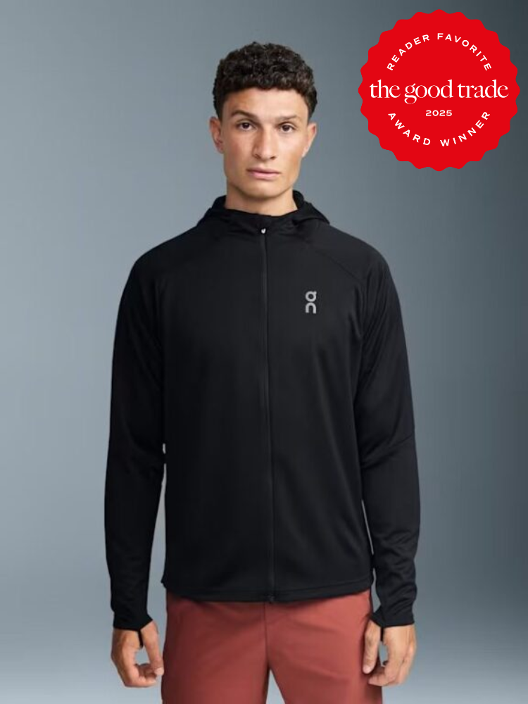 Man wearing a black hooded jacket and red pants, standing against a grey background. On the upper right is a red badge reading "Reader Favorite The Good Trade Award Winner 2025.