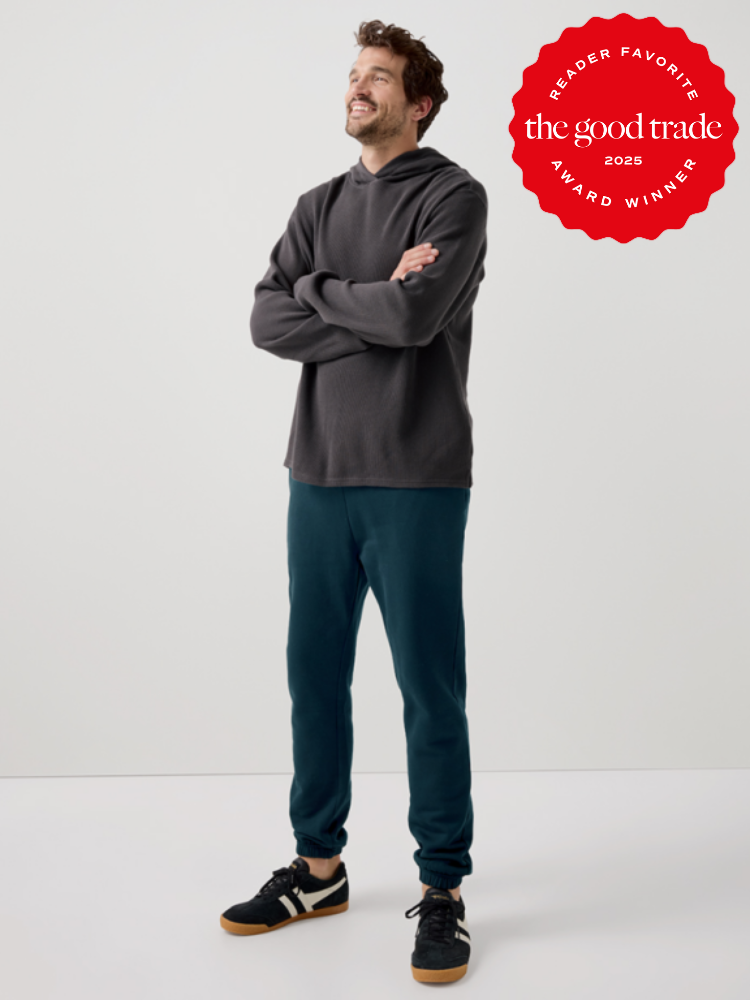 A person in casual attire stands smiling with arms crossed. A red badge on the image reads, "Reader Favorite, The Good Trade, 2025 Award Winner.