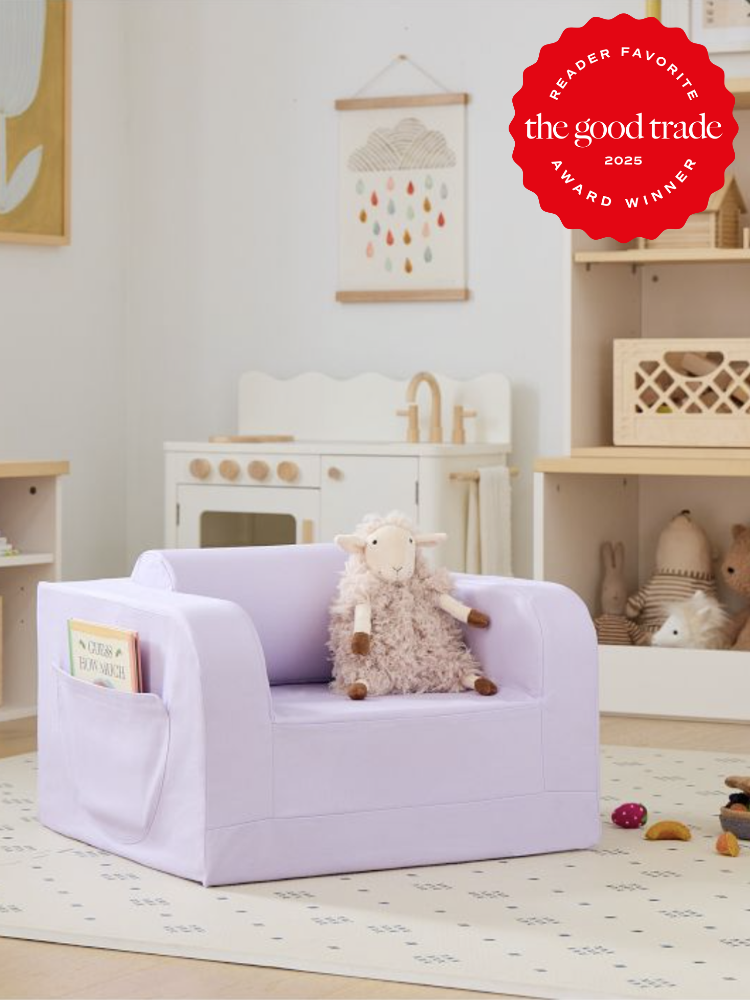 Children's playroom with a purple chair, a fluffy sheep toy, a book pocket, and a wooden play kitchen. Red "Reader Favorite" badge in the top right corner.