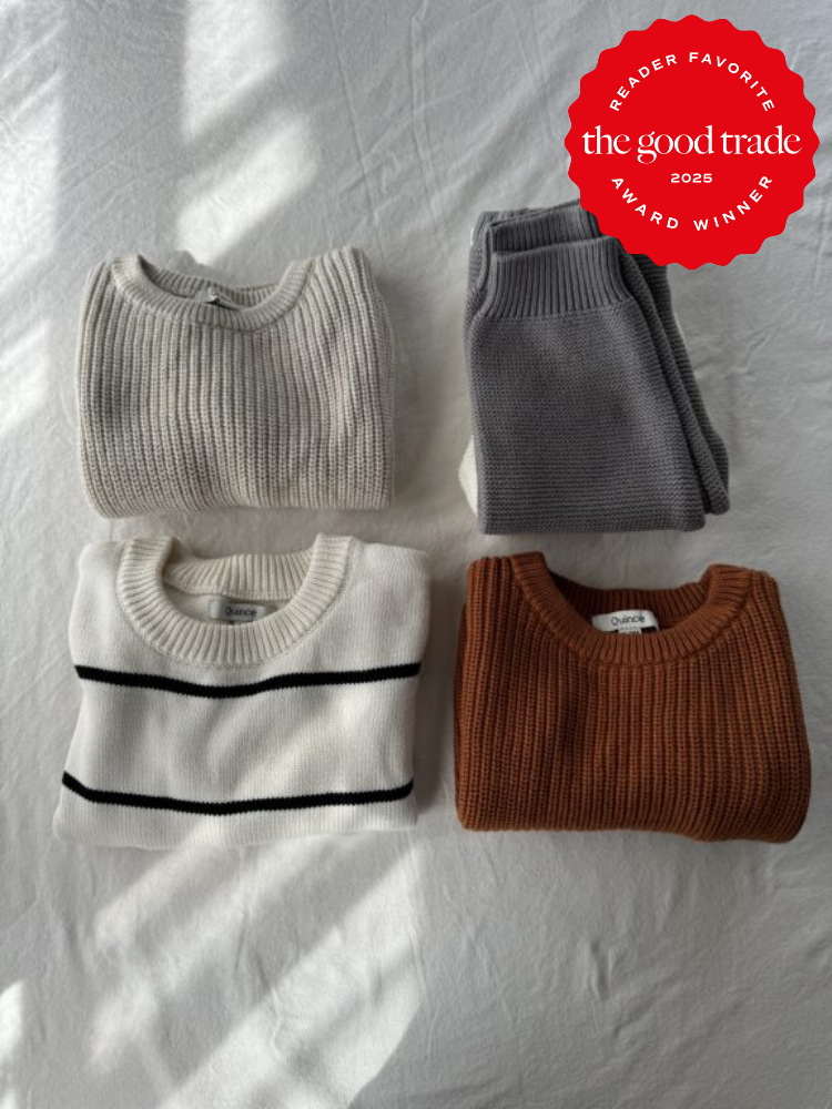 Four folded sweaters in various colors on a white surface, with a red "The Good Trade 2025 Reader Favorite Award Winner" badge in the top right corner.