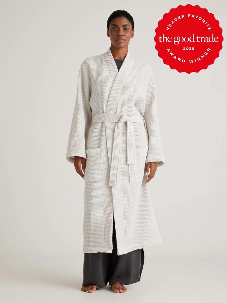 Person wearing a light-colored bathrobe stands against a neutral background. A red badge on the image reads "The Good Trade Award Winner 2025.