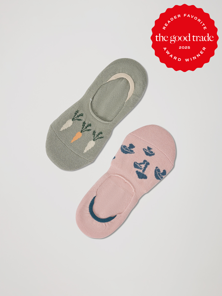 Two pairs of no-show organic socks with vegetable and floral patterns, displayed on a light background. A red badge reads "Reader Favorite, The Good Trade, Award Winner, 2025.