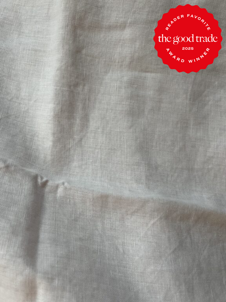 Light gray fabric with visible texture. Red badge in the top right corner with text: "Reader Favorite The Good Trade 2025 Award Winner.