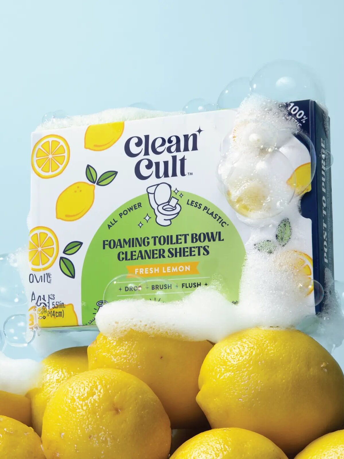 Box of Clean Cult Foaming Toilet Bowl Cleaner Sheets surrounded by lemons and bubbles against a blue background.