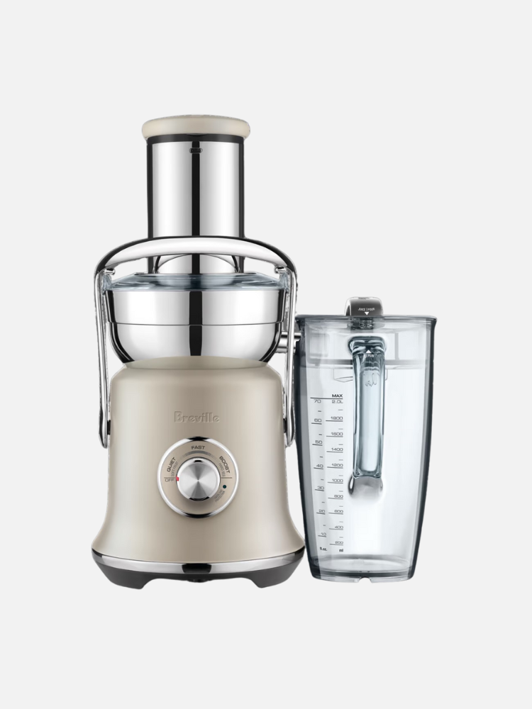 A beige and silver juicer with a clear collection jug. The juicer has a dial on the front and a tall feeding chute.