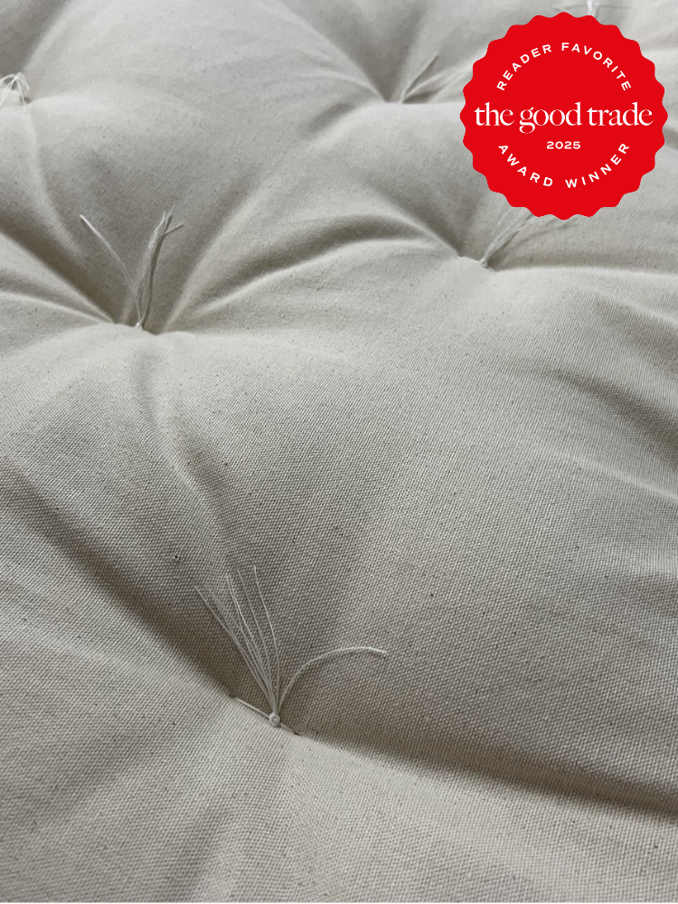 Close-up of a tufted cream fabric surface with loose threads. A red badge in the top right corner reads: "Reader Favorite, the good trade, 2025, Award Winner.