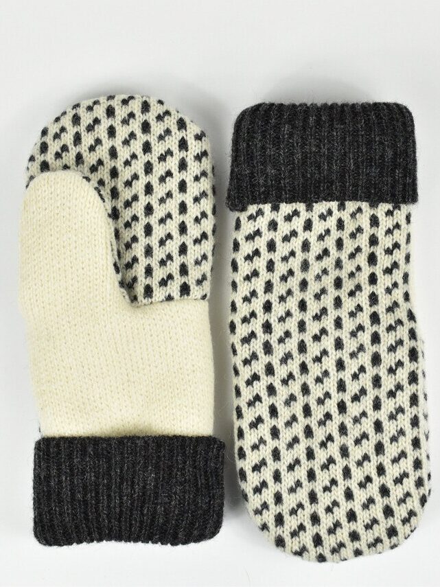 Two knitted mittens with black and white patterns, displayed on a plain white background.