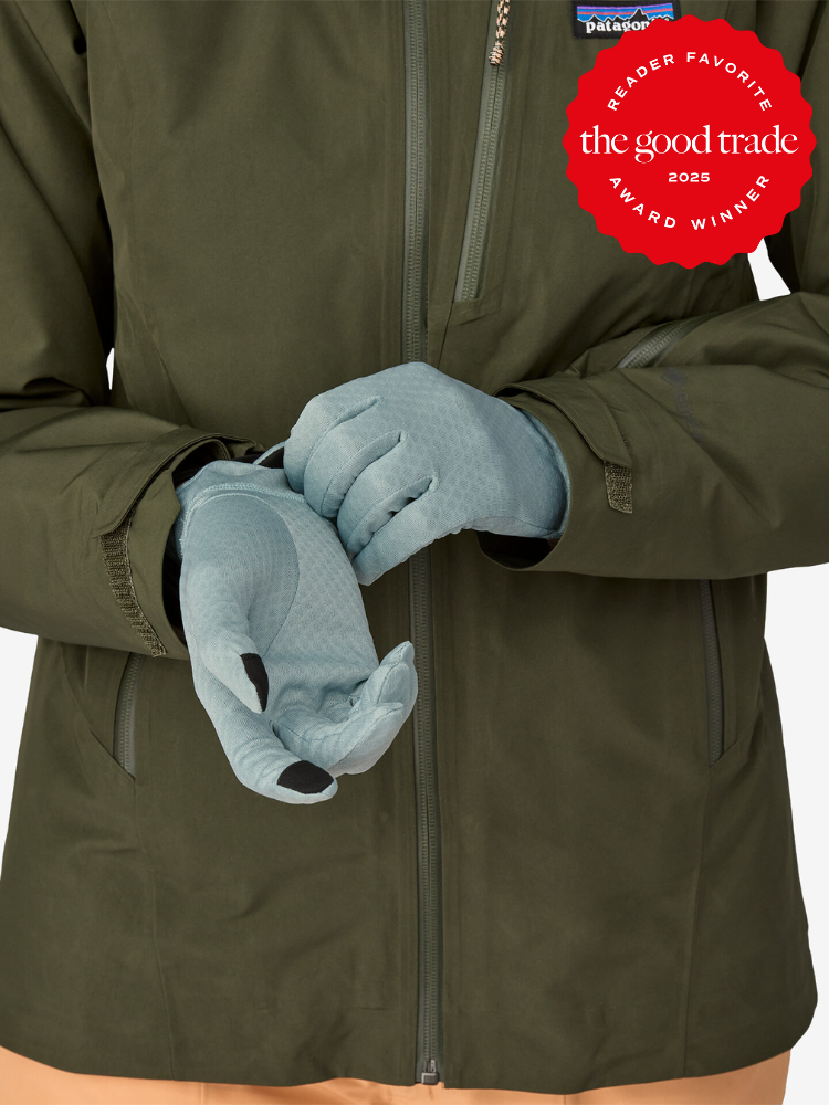 Person wearing a green jacket and light gray gloves with a focus on their hands. Reader Favorite Award from The Good Trade 2023 displayed in the corner.