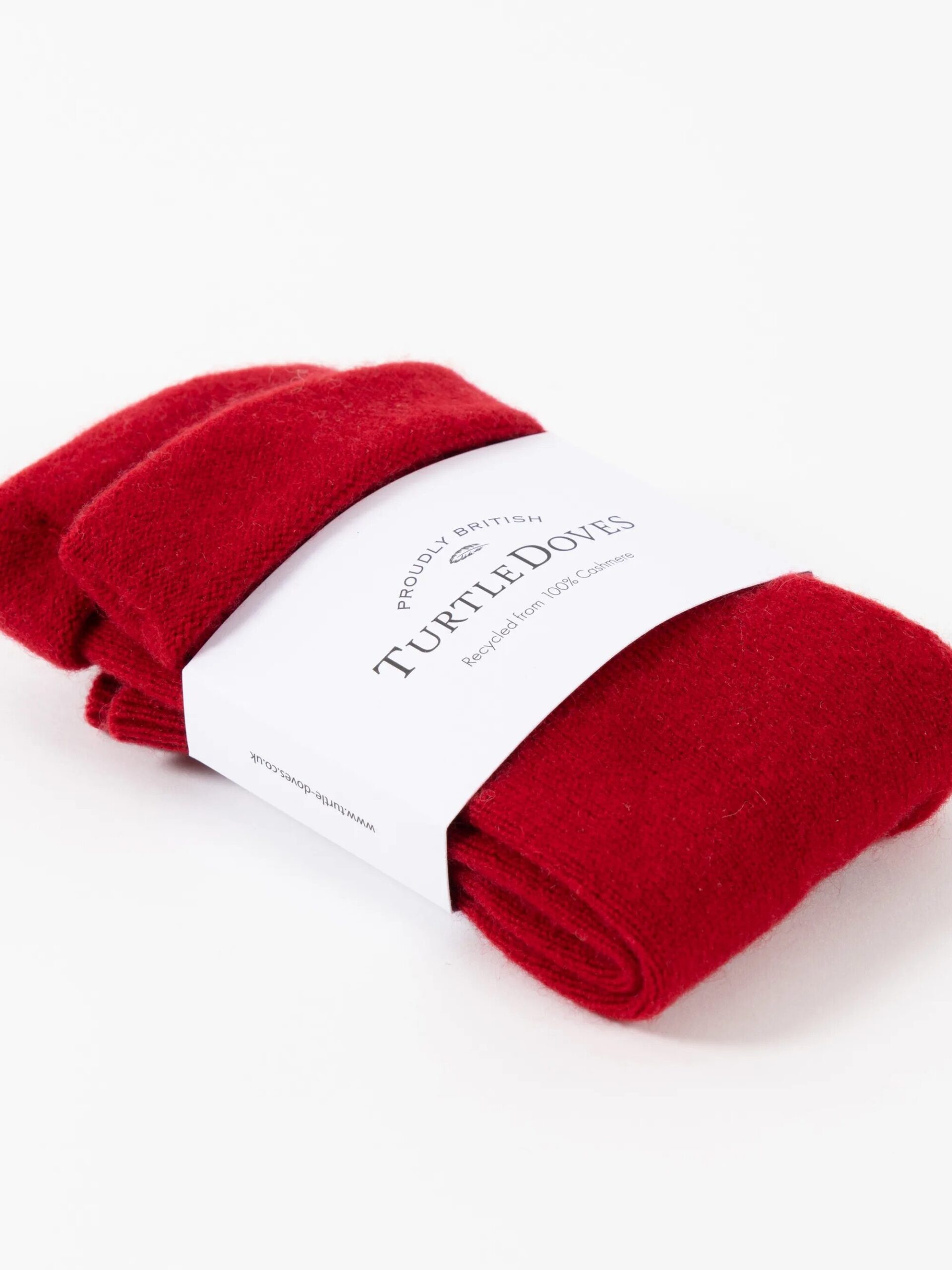 A pair of red socks wrapped in a white label with "Turtle Doves" printed on it.