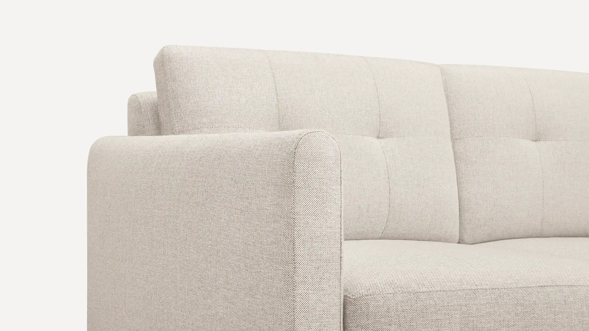 Close-up of a light gray sofa with a modern design, featuring a cushioned backrest and armrest.
