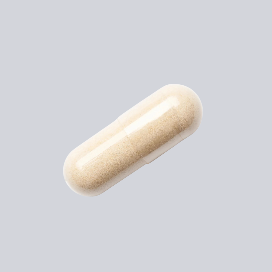 A single clear capsule filled with beige powder against a light gray background.