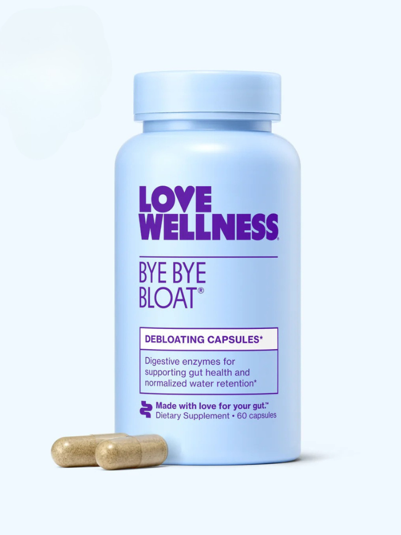 Blue bottle labeled "Love Wellness Bye Bye Bloat," with two capsules beside it. Text mentions debloating, digestive enzymes, and 60 capsules as a dietary supplement.