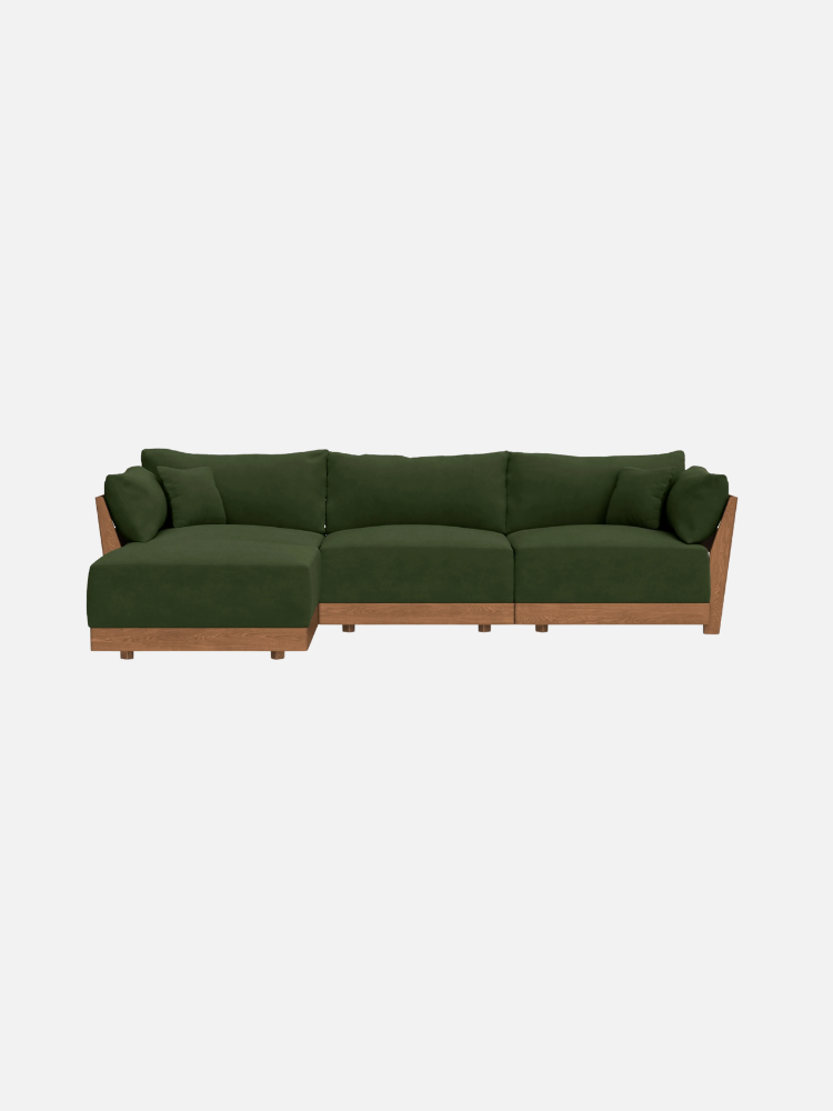 Green sectional sofa with wooden frame, featuring left chaise lounge section and two seat cushions.