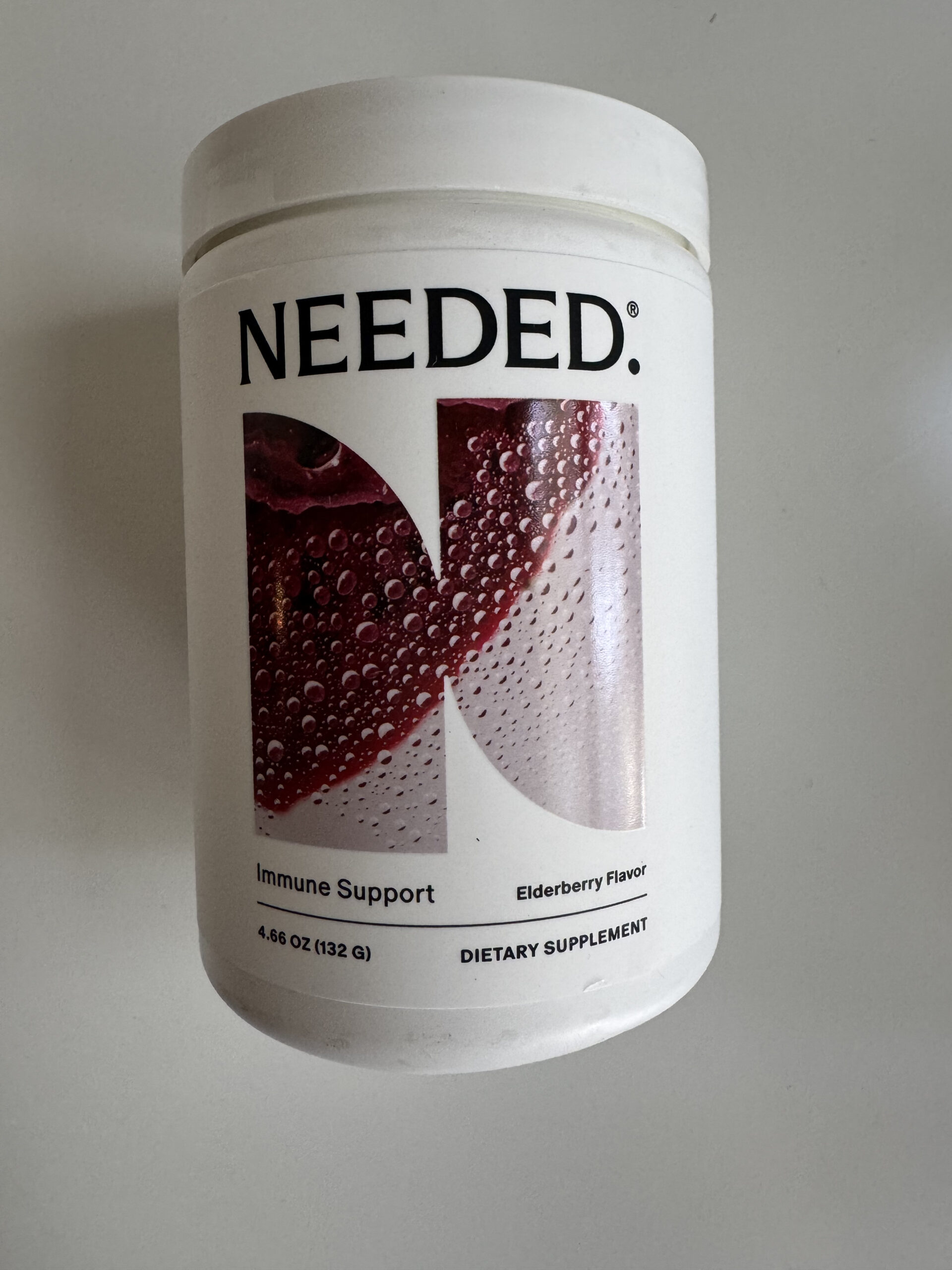 A white container labeled "NEEDED" for immune support, elderberry flavor, dietary supplement, 4.66 oz (132 g).