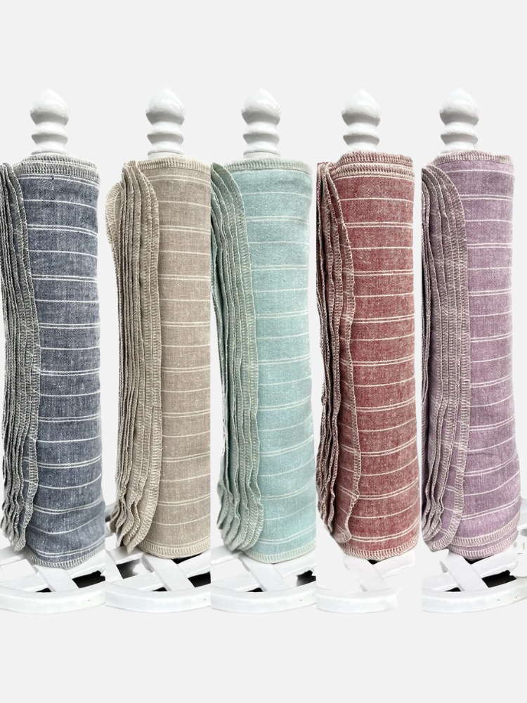 Five stacked rolls of reusable cloth towels in gray, beige, blue, red, and purple, each with white stripes, are displayed on holders against a white background.