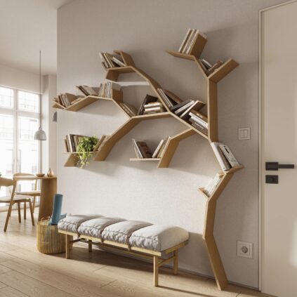 Wall-mounted tree-shaped bookshelf with various books. Below it, a padded bench and side table with decor. Door on the right, dining area visible in the background.