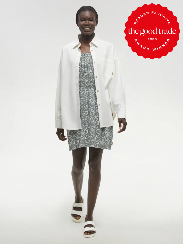 Smiling person in a patterned dress and white shirt walking, wearing sandals. Red badge on the image reads "The Good Trade Reader Favorite Award Winner 2025.