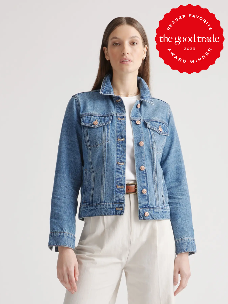 A person wearing a blue denim jacket over a white shirt and light pants stands against a plain background. A red badge in the corner reads "Reader Favorite, The Good Trade, 2023 Award Winner.