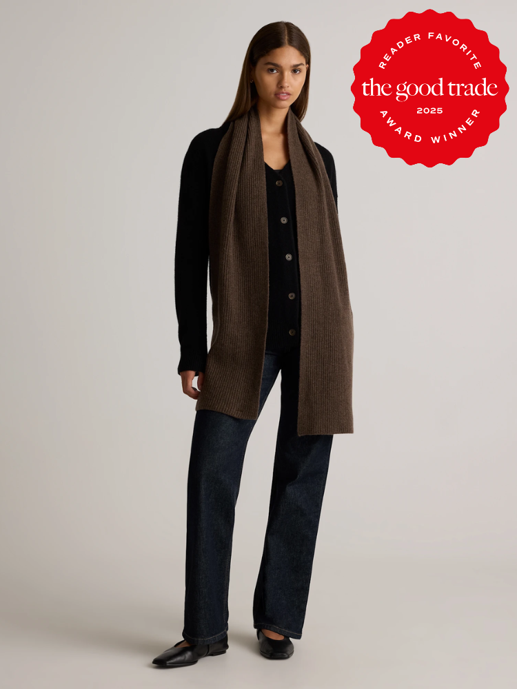 Person wearing a long brown scarf, black cardigan, jeans, and black shoes. Red circular badge reads "Reader Favorite, the good trade, 2023 Award Winner.