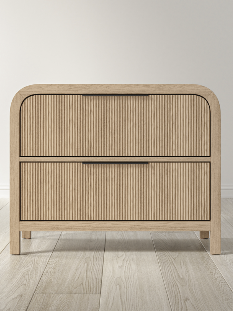 Wooden sideboard with two drawers featuring a ribbed pattern, set against a light-colored wall and floor.
