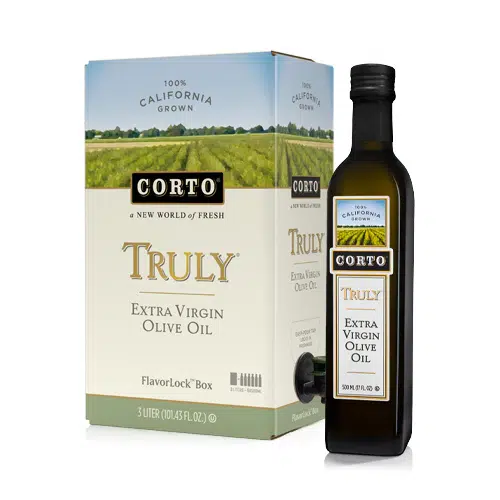 A boxed and bottled version of Corto Truly Extra Virgin Olive Oil. The packaging highlights "100% California Grown" with a spout on the box for easy dispensing.