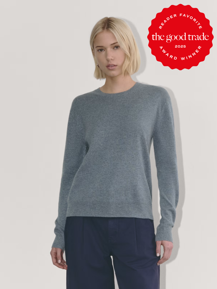 Woman wearing a gray sweater and navy pants against a plain background. Red award badge in the top-right corner says "the good trade 2023 Reader Favorite Award Winner.