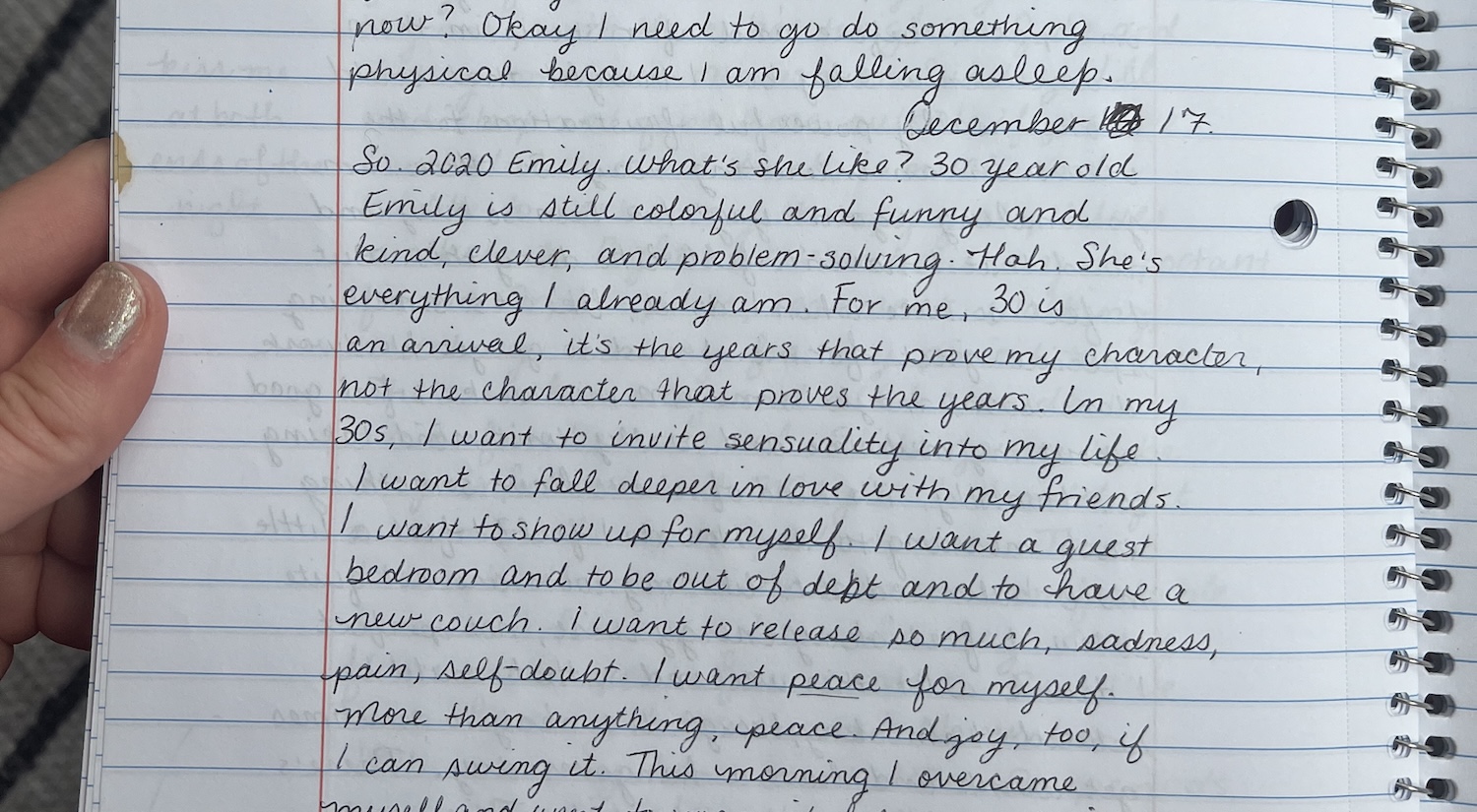 Hand holding a notebook open to handwritten text discussing a personal reflection on life in their 30s, focusing on self-discovery, personal growth, and overcoming challenges.