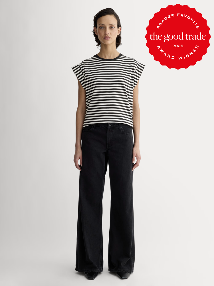 Person wearing a black and white striped shirt and black wide-leg pants stands against a plain background. A red emblem in the corner reads "The Good Trade 2023 Reader Favorite Award Winner.