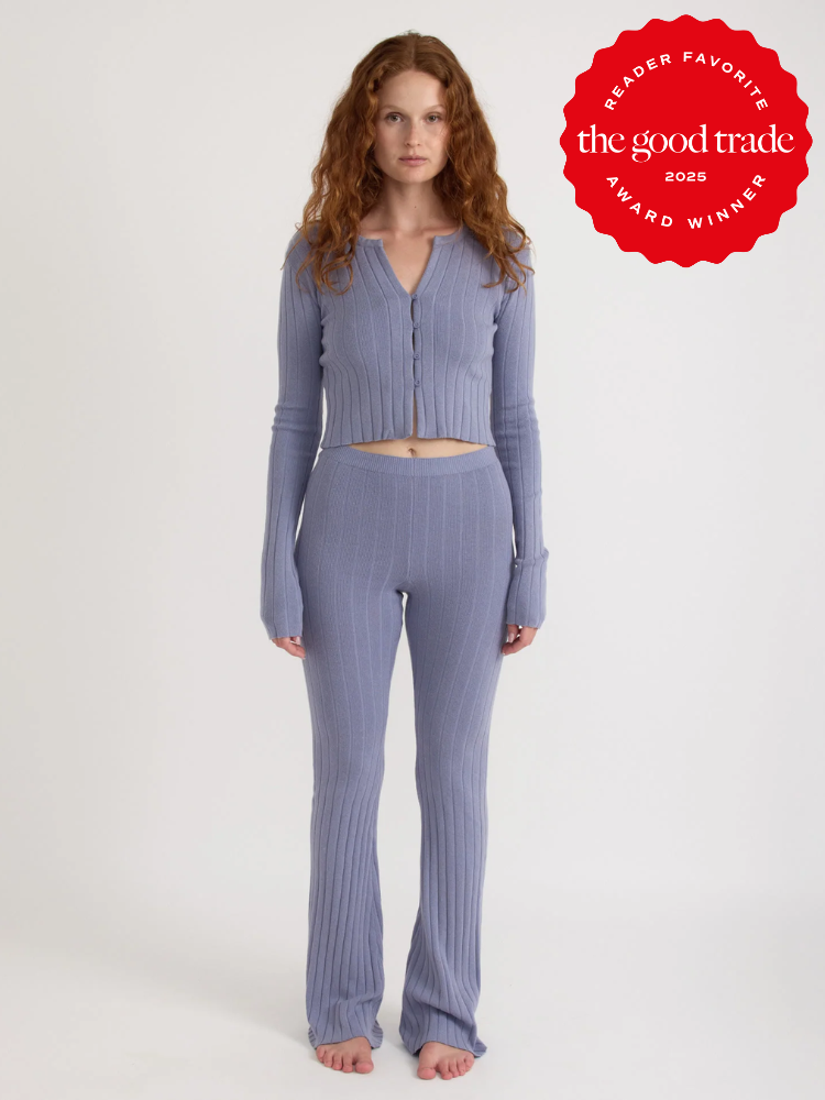 Person wearing a textured lavender knit outfit stands barefoot against a plain background. A red badge reads "Reader Favorite - The Good Trade Award Winner 2023.